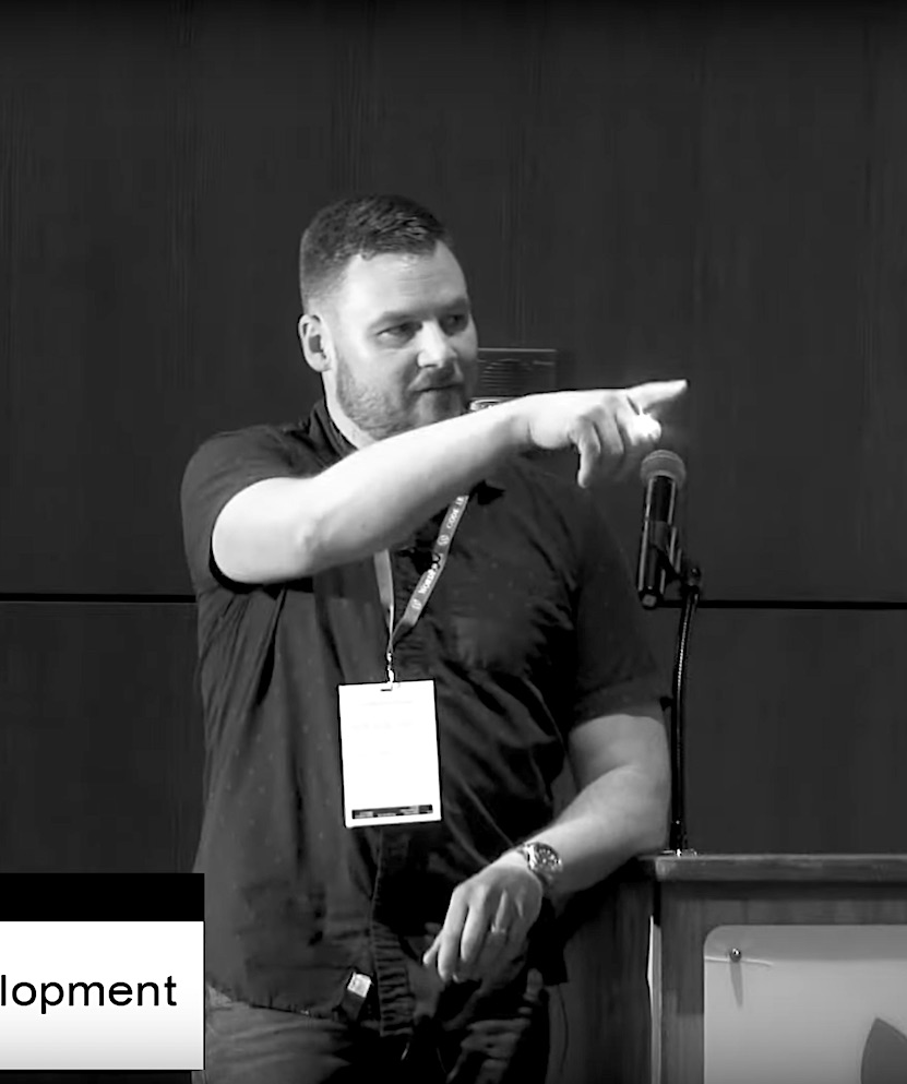 Man speaking in front of a crowd